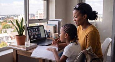 a mother and daughter with a laptop