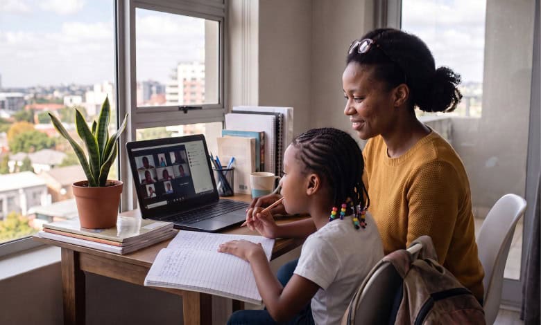 a mother and daughter with a laptop