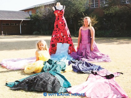 Belinda Pretorius and a friend Chantelle Bezuidenhout sit among some of the evening dresses girls could choose from.