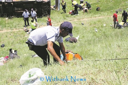 A police officer helping one of the injured passengers up the embankment as 16 people were transported to Witbank Provincial Hospital.