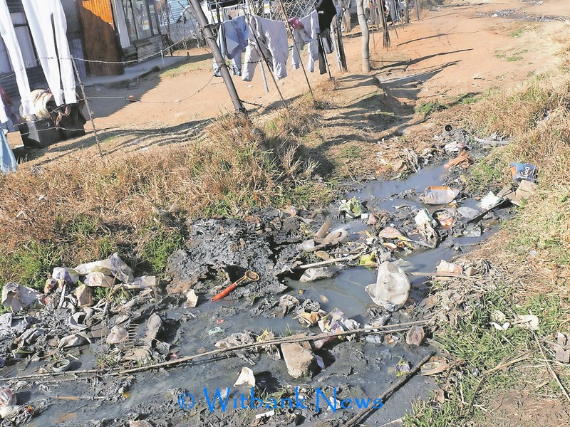 Illegal cable connection with running water across a street in Hlalanikahle.