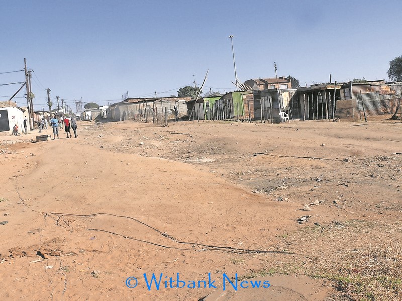 Illegal cable connections run across a street in Hlalanikahle, the street is widely used.