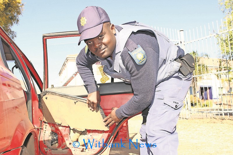 Const Michael Ngobeni shows the dagga hidden behind door panels in a Toyota Corolla.