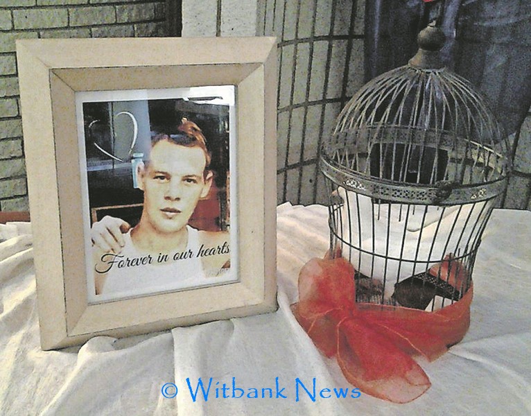 The picture of the late Mr Steven Roux (25) and a white dove on the table on Friday, June 26 at the NG Kerk Kriel where his funeral took place.