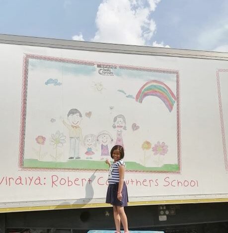Niralya Padayachy in front of her winning sketch on a delivery truck. (Photo supplied)