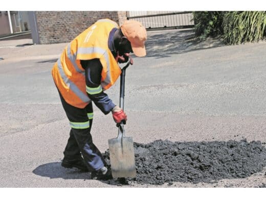 Justin Maheu is busy fixing a pothole.