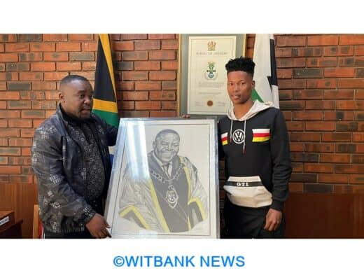 Mayor Vusi Nhlapho and Sizwe’s new mentor, Remember Makgoga, holding a portrait drawn by the artist from scratch.