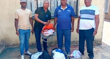 Thabiso Mogoba, Tefo Maraba, Phillip Rapakgadi Phatudi and Fani Ndlovu with some of the donated clothes.