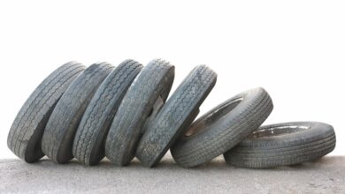 8310920 - a row of old obsolete tires isolated on white