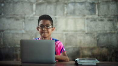 Asian boy using laptop on the table,come back to shcool