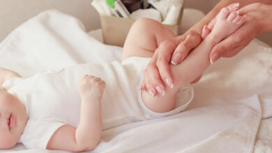 Baby and hands of mother, soft focus background