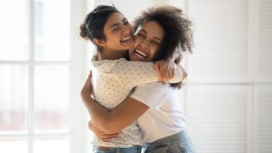 Happy Multiethnic Girlfriends Have Fun Hugging Indoors