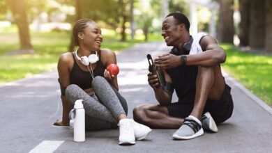 Joyful,African,American,Couple,Resting,After,Exercising,Outdoors,,Sitting,On