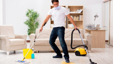 Man cleaning home with vacuum cleaner