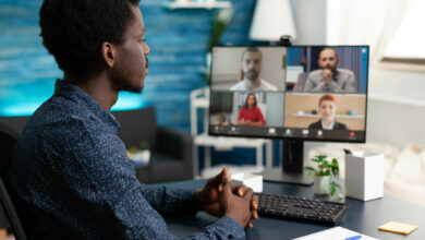 Man of african ethnicity using conference webcam communication