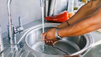 Man washing his hands in the kitchen