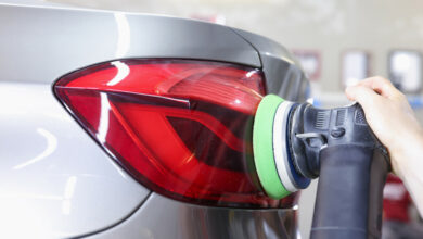 Powerful headlights. Particle view of modern luxury cars parked indoors at daytime