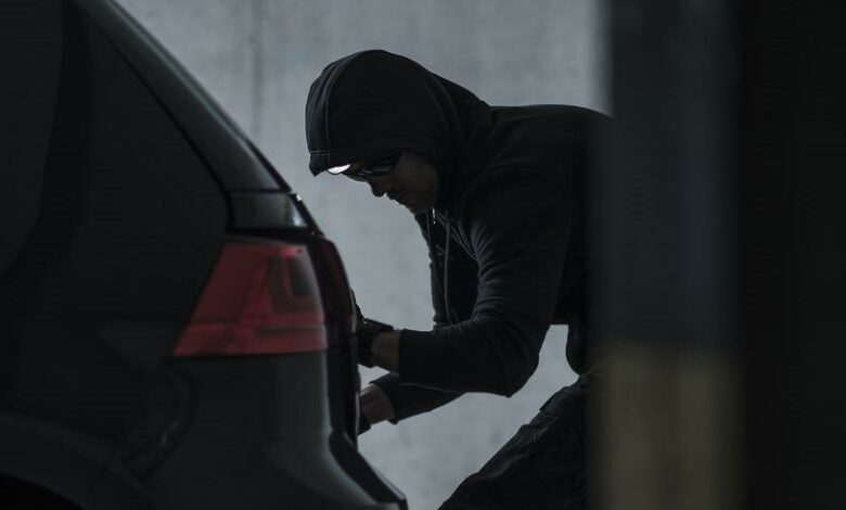 side-view-of-burglar-jacking-car-in-basement-royalty-free-image-1574291612