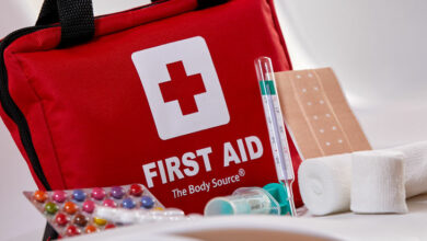 Small red First Aid kit with pills and bandages