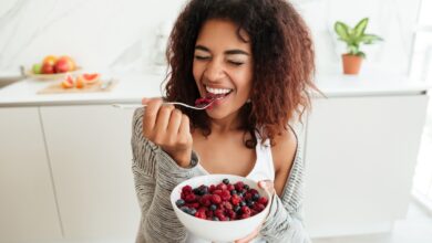 Young,Healthy,Laughing,African,Woman,Eating,Breakfast,And,Fruits,In