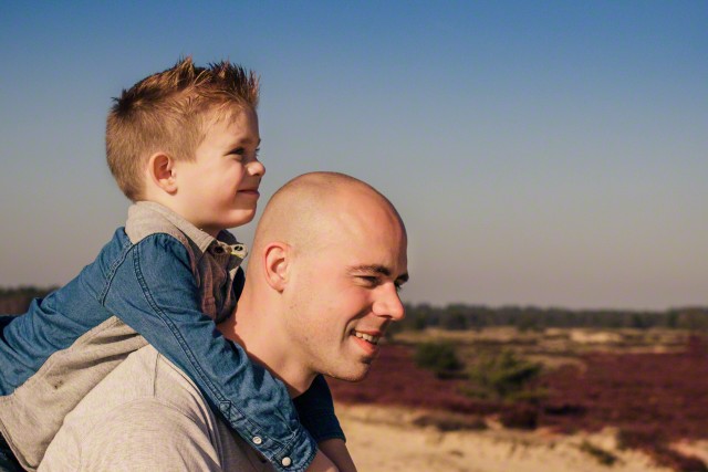Father giving his son a piggyback ride