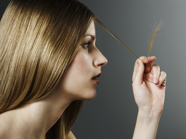 Woman Examining Split Ends