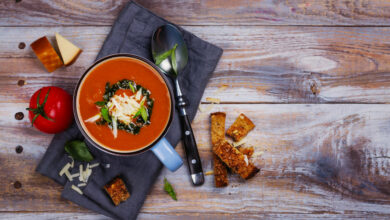 Tomato soup with pesto sauce and parmesan cheese