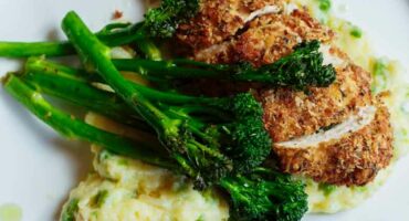 Chicken Kiev, pea mash and garlic butter Tenderstem broccoli