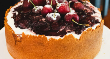 Air fryer oven cheesecake topped with fresh cherries