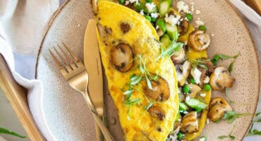 Double mushroom omelette with peas, asparagus and feta