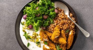 Greek-style chicken bowl with whipped feta and kale salad