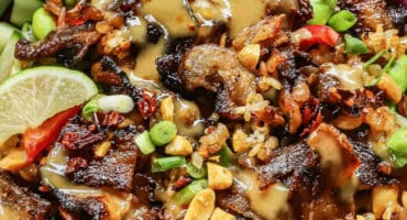 Crispy pork salad with caramelised rice and peanut dressing