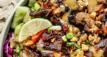 Asian-inspired pork belly salad with veggies and caramelised rice