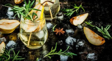 Sweet pear cocktail with rum, anise and rosemary