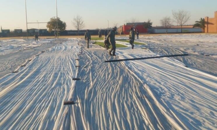 Rugby field covered to protect it from frost