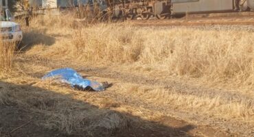 Body of man lying under space blanket