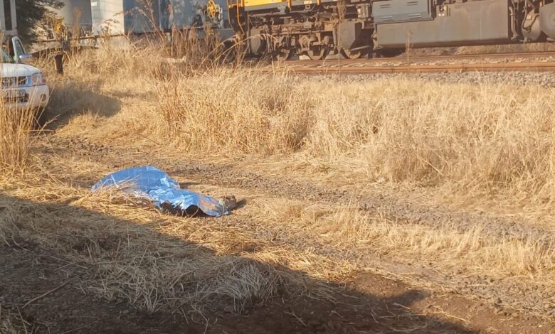 Body of man lying under space blanket