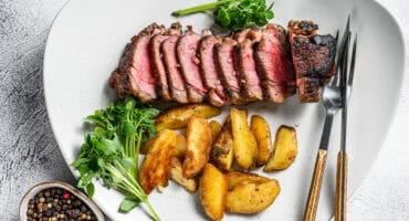 Coffee-rubbed steak with garlic potato wedges
