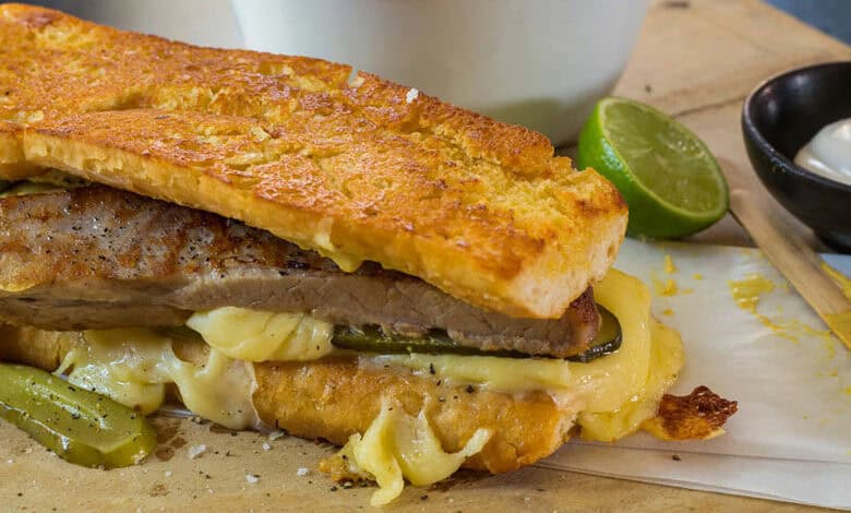 Pork belly Cuban sarmie with dipping sauce and extra pickles