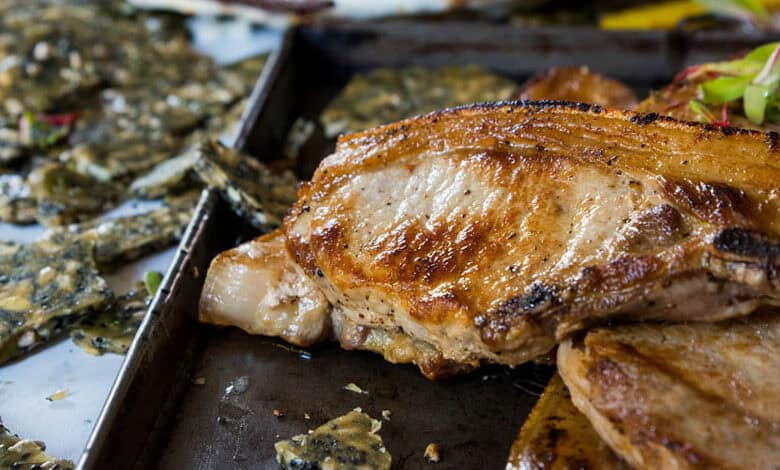 Coconut and garlic pork chops with roasted carrots and seed brittle