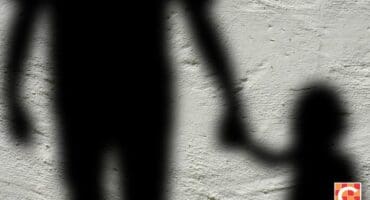 shadow of adult holding a child's hand