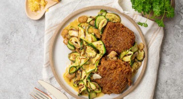 Garlic butter beans with charred courgette and chicken thighs