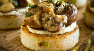 Pap cakes topped with mini portabellini mushrooms