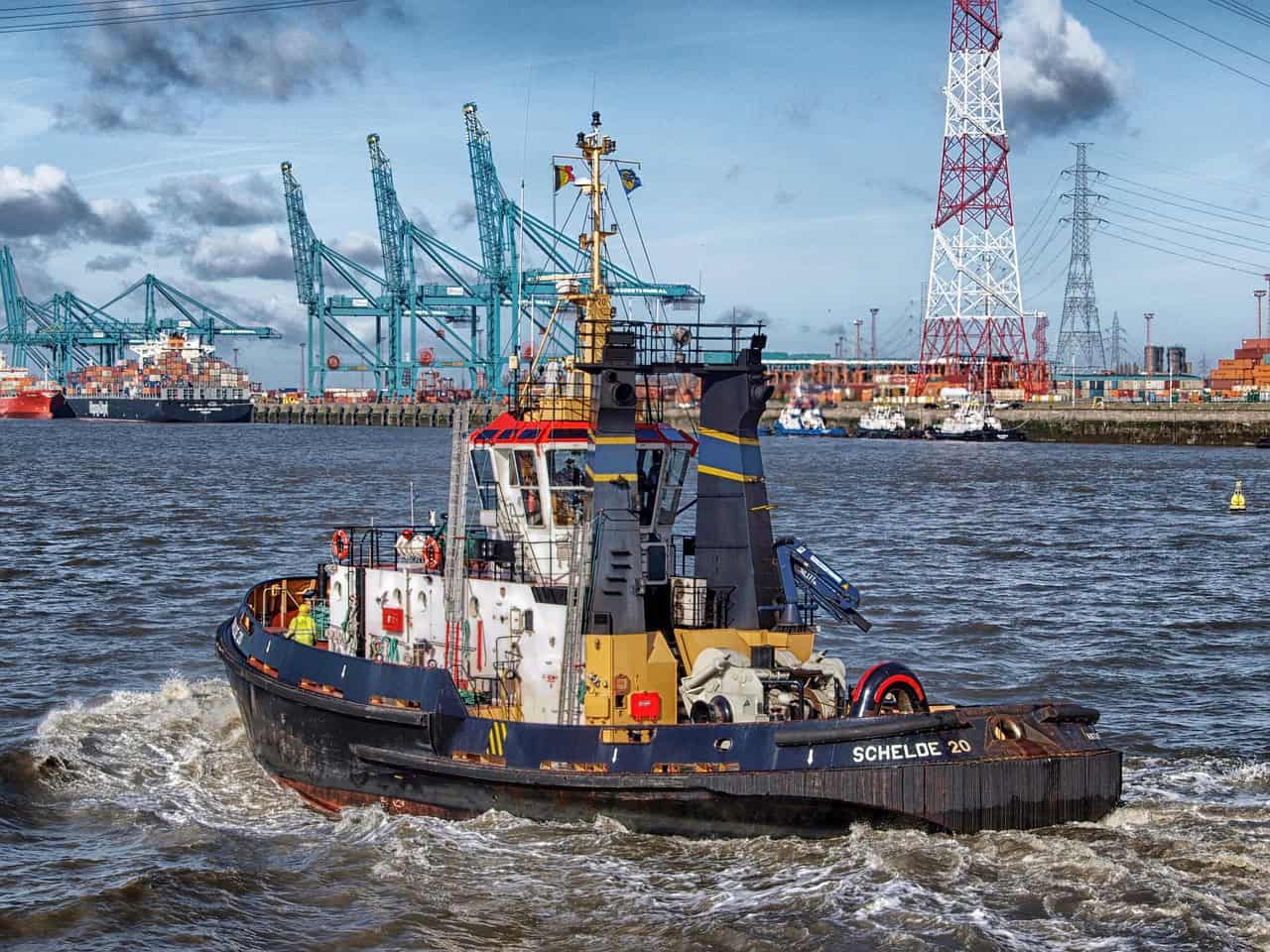 boat in durban harbor with cargo ships in background