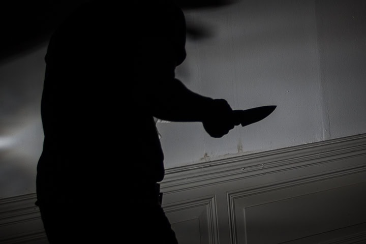 silhouette of man holding a knife