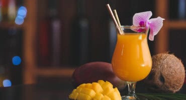 Mango coconut rum cocktail with a twist of lime
