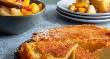 Sticky jam pudding with warm fruit and custard