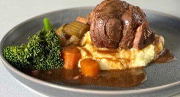 Slow-cooked lamb shank deglazed with red wine