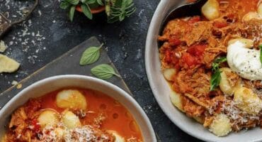 Slow-cooked pork ragù spooned over gnocchi