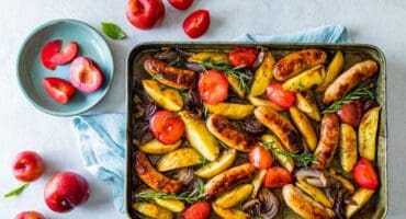 Sticky spiced sausage and plum traybake recipe